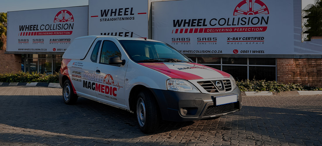 mobile-medic A wheel collision mag-medic vehicle parked in front of a wheel collision store