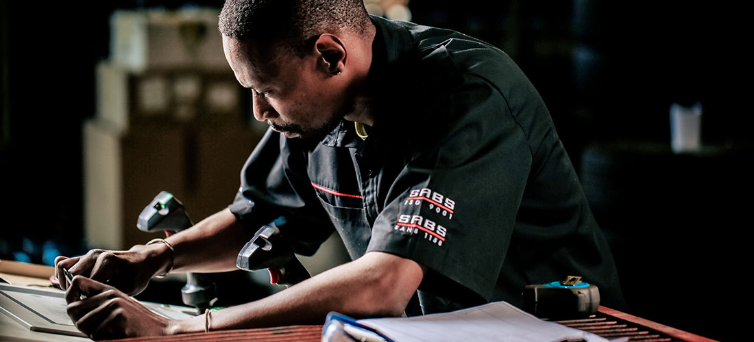A wheel collision technician operating advanced machinery