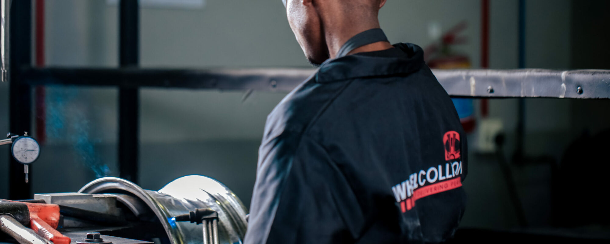Wheel Repair Specialist using a welding machine to repair an alloy wheel